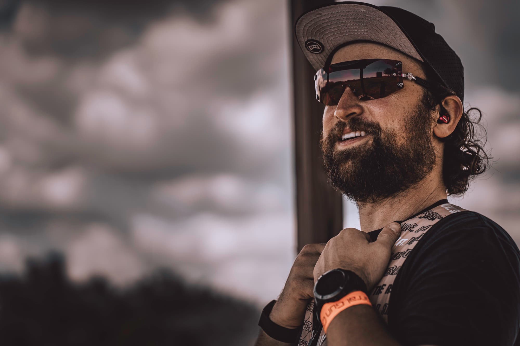 David Radulovich smiling in shooting glasses, with the field reflected in the lenses.