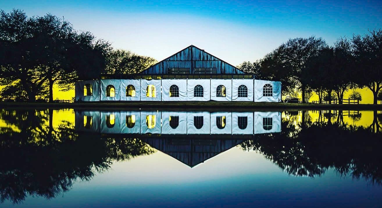 A building reflected cleanly across still water like a structured system.