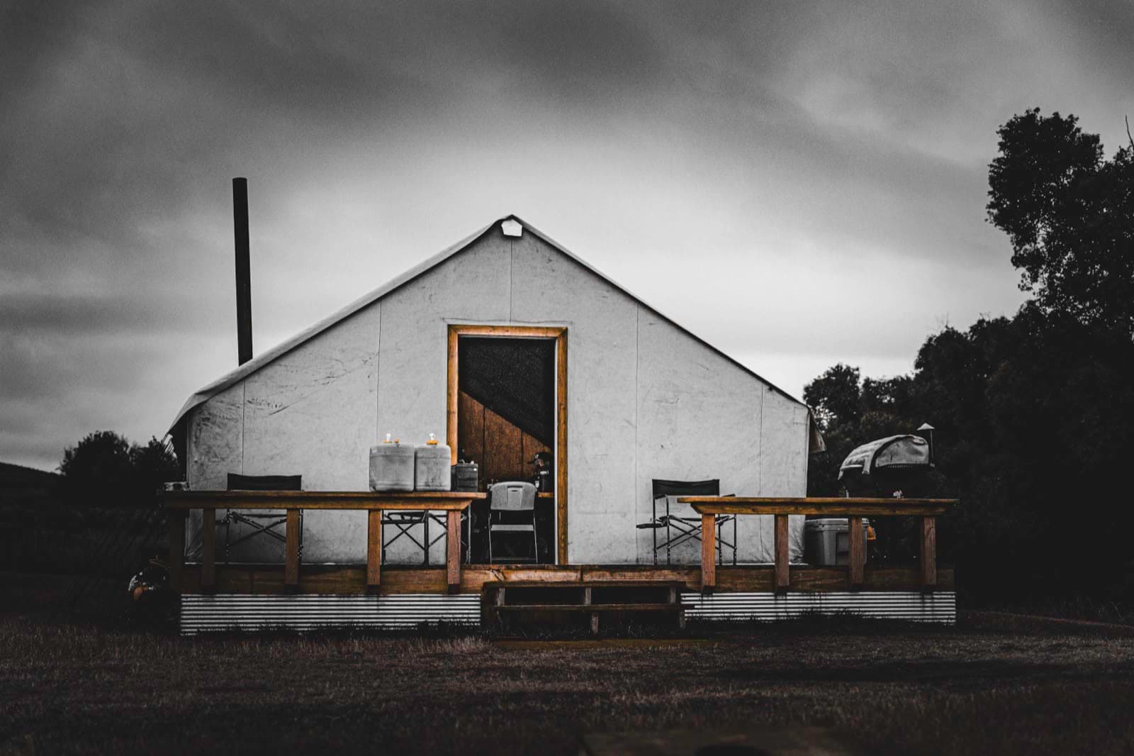 A simple white field building framed by dark sky and precise edges.