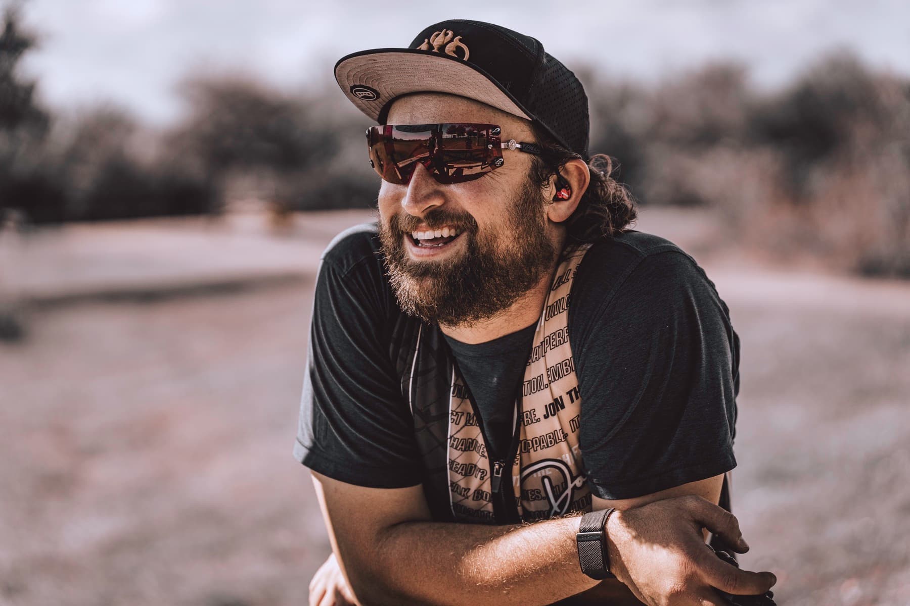 David Radulovich smiling at a shooting ground during a quiet moment between work.